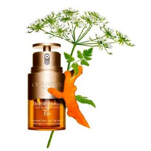 Das Clarins Double Serum mit einer grünen Blume vor einem weissen Hintergrund