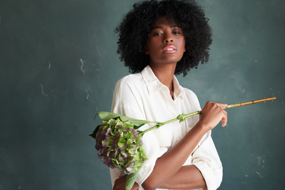 Female model holding green plant