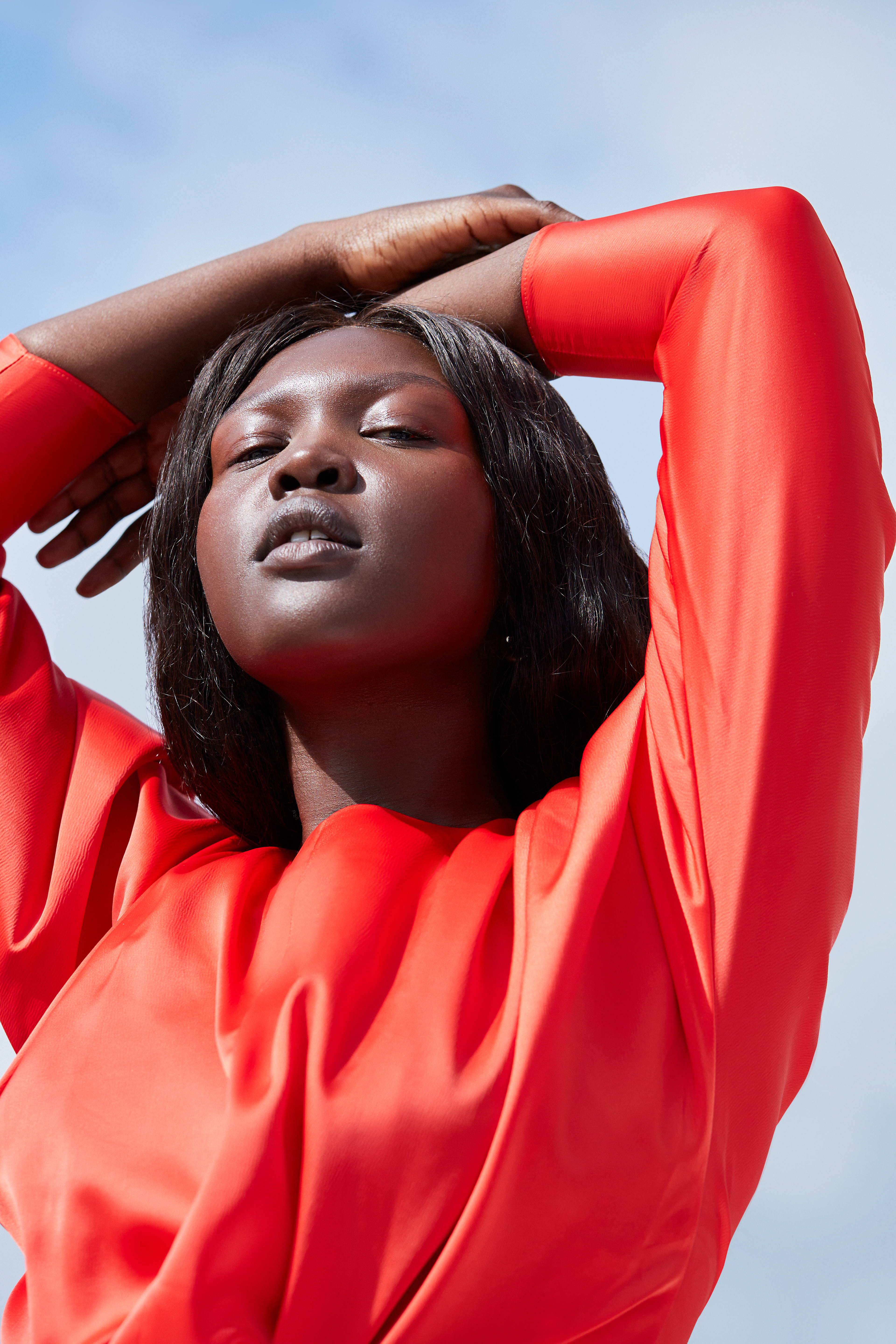 Shot 4_394 Female model with hands in the hair looking into the sun