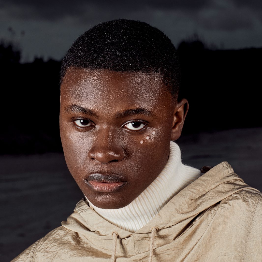 male model staring into camera with dark background