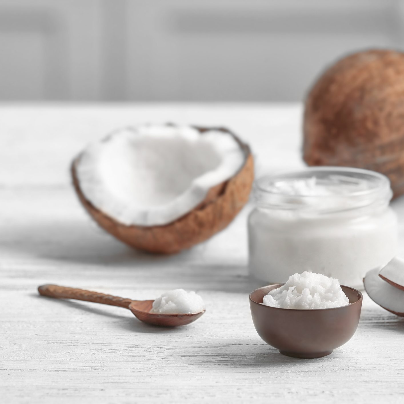 Fresh coconut oil and nuts on wooden table